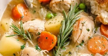 Bowl of comforting slow cooker white wine chicken stew with vegetables