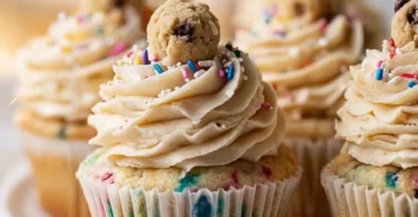 Delicious cookie dough cupcakes topped with creamy frosting and cookie dough bits