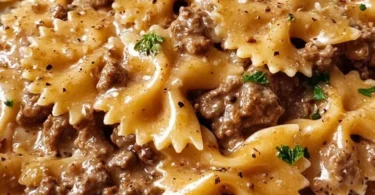 Delicious creamy beef pasta served in a bowl, garnished with parsley