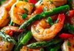 Healthy shrimp asparagus stir fry served in a bowl with vibrant colors