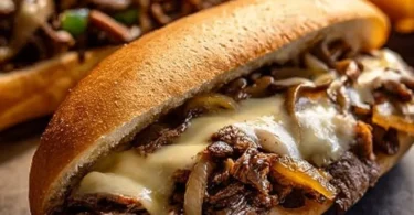 Delicious slow cooker Philly cheesesteak piled high with melted cheese and savory meat