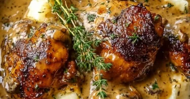 Delicious smothered chicken thighs in rich gravy served on a plate