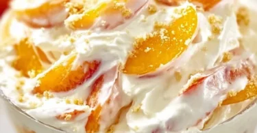 Delicious Peach Cheesecake Salad with fresh peaches and cream cheese topping.
