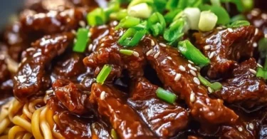 Delicious sticky beef noodles served in a bowl with vegetables and sauce
