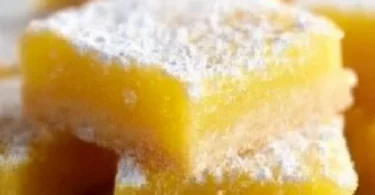 Freshly baked super easy lemon bars topped with powdered sugar.