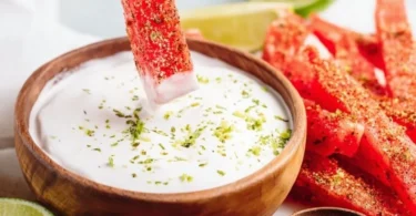 Tajin-coated spicy watermelon fries served on a plate