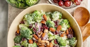 Vegan broccoli salad with colorful veggies and dressing in a bowl